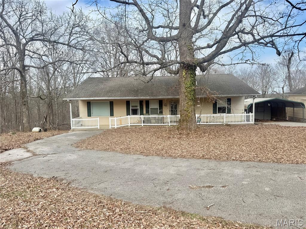 This three-bedroom, two-bathroom single-story ranch offers over 1,500 square feet of open concept  living space on more than 16 fully wooded acres of unincorporated ground. Located just 10 minutes from the amenities of Fredericktown, it provides privacy without sacrificing convenience. Inside, the home features an open-concept living, dining, and kitchen area designed for functional everyday living. The kitchen includes a walk-in pantry and brand-new appliances that are less than a year old. The HVAC system and hot water heater have both been updated within the past two years, offering added efficiency and reliability. All three bedrooms are spacious, and the bathrooms are generously sized to comfortably serve the household. The home also provides ample storage throughout. Exterior features include a fully covered front porch and a fully covered back deck, giving you usable outdoor space year-round. Parking and workspace are a major advantage with a one-car detached garage, a two-car carport, and a large workshop building capable of fitting an additional four to five vehicles or serving as a hobby or storage space. This property combines acreage, functional living space, and substantial outbuildings in a convenient location close to town.