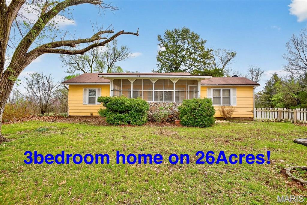 This charming home of yesteryear invites you to slow down and imagine life a little simpler. Set on 26+ acres with a beautiful mix of open pasture and mature woods, the property feels like a place where mornings begin with coffee on the porch and end with sunsets stretching across your own land.
The 3-bedroom, 2-bath home offers a warm, nostalgic feel, ready for someone with vision to make it their own. A carport and several outbuildings provide space for equipment, hobbies, or livestock, making it easy to picture the beginnings of your own small family farm. There is water and electric hook-up for a mobile home if you're looking for space for a second living area. 
With a little TLC, this property holds endless potential—whether you dream of gardening, raising animals, or simply enjoying wide-open space. Being sold as-is, it’s an opportunity to create something truly your own in a peaceful, rural setting. Easy access to I44, about 1.8 miles, and Fort Leonard Wood just east.