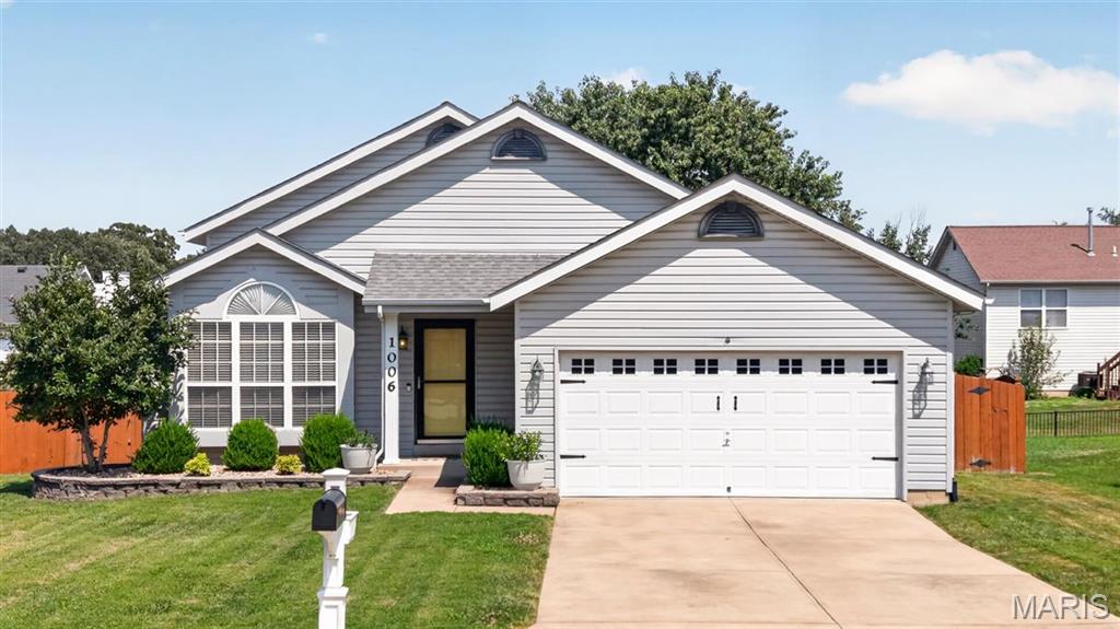 Welcome home to this beautifully updated 3 bedroom, 2 bath multi-level home nestled in the heart of Wentzville! From the moment you step inside, you'll love the soaring vaulted ceilings, windows and skylights that flood the home with natural light, and the warm hardwood laminate flooring that creates an inviting atmosphere. The spacious living room opens to the kitchen and breakfast area, offering an ideal layout for everyday living and entertaining. The kitchen features white cabinetry, stainless steel appliances, subway tile backsplash, and an adjacent dining area complete with a charming window seat overlooking the backyard. Retreat to the generously sized primary bedroom featuring vaulted ceilings, while two additional bedrooms provide plenty of space for family, guests, or a home office. Both bathrooms have been tastefully updated with modern finishes and stylish fixtures. The finished walkout lower level offers an expansive rec room perfect for movie nights, game days, or a playroom, with direct access to the backyard. Outside, enjoy the fenced yard with two patios ready for summer barbecues, relaxing evenings, or letting kids and pets play freely. Conveniently located near parks, schools, shopping, restaurants, and easy highway access, this move-in ready home has everything you've been looking for!
