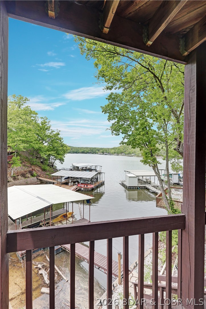 NEW PRICE! $349,000! LAKE VIEWS • PEACEFUL COVE • FISHING • 50' LAKEFRONT • UPDATED HOME • RENTAL OPTIONS
Amazing year-round lake views! Beautifully updated 3BR/2BA lakefront home in desirable Indian Creek Cove, known for great crappie fishing and abundant catfish. Enjoy 50' of lakefront, expansive lakeside decks and a private 2-slip dock, usable April–December, ideal for a smaller boat, fishing boat or PWC. NO rental restrictions! Open floor plan features two primary suites with walk-in closets, granite-surround fireplace and updated kitchen with granite countertops, subway tile backsplash & Whirlpool stainless appliances. Smart-home features include Ring cameras/doorbell and Nest thermostat. Lower level offers 9' ceilings and 275 SF of unfinished space ready for a game room, additional living area or guest suite. Convenient by water to Jolly Rogers and other lake favorites. Updated, waterfront and priced at $349,000—come enjoy the lake lifestyle!