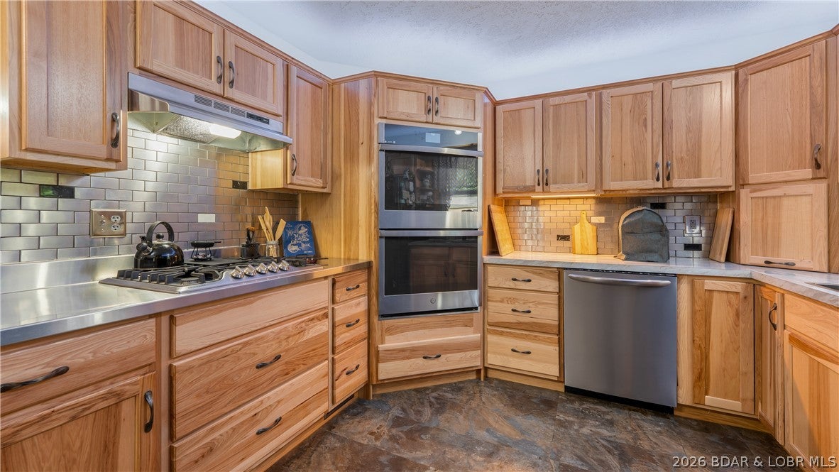 This well built, updated home can be your forever home! The main level features 1-level living with lots of natural wood and stone, including a beautiful staircase. Plus an all new kitchen. You’ll also find the primary bedroom suite, laundry, a half bath, and the garage on the main level. The lower level offers a spacious walkout family room,  2-3 additional bedrooms, a full bath, utility room, and a bonus room that can be used for an office, hobbies, a game room, or extra sleeping space. The finished rooms under the garage can double as a storm shelter. Outside, the flat second parcel provides space for an RV or add a shop building. There is a nice shed on it too. Your boat slip in the community dock is just a short golf cart ride away. The golf cart, boat, and lift are all included. Seller is offering a 1-year home warranty. Located down O Road in Laurie at the 8MM. Road is paved to the property. Community water and Gravois sewer district. Peaceful neighborhood close to Tap and Grill, Indian Rock golf, the movie theater, and some of the best restaurants at the lake! Seller motivated - come take a look! Priced below recent appraisal!