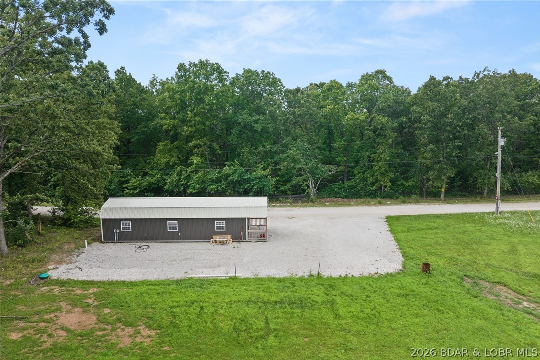 Discover the perfect blend of simplicity, privacy, & endless opportunity with this charming 2024 built 2 bed/1 tiny home situated on 23 beautiful open acres in Gravois Mills MO. Whether you're looking for a peaceful full-time residence, a relaxing weekend getaway, a recreational retreat, future family compound, hobby farm, or the ideal location to build your dream home, this versatile property offers something for everyone. This property has 2 wells (one well for future build) new septic system, rv hook-up, brand new appliances, spray foam insulation, loft for storage, custom cabinets, LVP & so much more! Enjoy wide-open views, abundant wildlife, breathtaking sunrises & sunsets, & plenty of space for gardening, hobby farming, horses, livestock, hunting, ATV riding, hiking, or simply enjoying the outdoors. This property offers flexibility for a variety of uses while providing the peace & privacy of country living yet still allowing convenient access to nearby amenities. Whether you're searching for a homestead, investment opportunity, or private escape, this unique property is ready to make your vision a reality. Rare opportunity to own a versatile property w/unlimited potential.