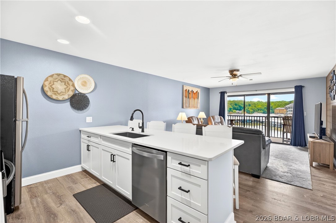 Welcome to the ultimate turn-key lake retreat at Harbor Point Condominium, situated right in the heart of Osage Beach! This spectacular 2-bedroom, 2-bathroom unit offers the highly coveted combination of walk-in access, top-floor privacy, and a dedicated parking spot right out front. Boasting over $50,000 in meticulous annual updates, this home features a new furnace and water heater, stylish kitchen cabinets, all-new appliances, LVP flooring, new doors, brand-new carpet in the bedrooms, and smooth ceilings with the popcorn removed. The updates flow right into the guest spaces, including a luxurious Onyx shower and a newly updated, fully screened deck. Perfect for boaters, this condo includes a 10x26 boat slip featuring a rare 6-foot wood patio section for lakeside lounging. Complete with resort-style community amenities—including a waterfront pool, tennis/pickleball courts, and a community laundry facility—this stunning, fully updated unit is ready for immediate summer enjoyment.