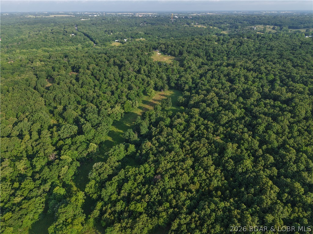 Escape to the outdoors while staying just minutes from town! This +/- 55-acre tract offers the perfect combination of privacy, recreation, and future homesite potential in the heart of the Missouri Ozarks. A hunter's dream, the property is loaded with trophy whitetail deer and wild turkey, featuring multiple hunting blinds and an established food plot to attract and hold wildlife. Enjoy shared access to a pond with split ownership, adding both beauty and recreational opportunities. The land is fenced on three sides and offers several excellent building sites with scenic views and abundant wildlife right outside your door. Modern conveniences are already nearby, with high-speed fiber optic internet and electric service located adjacent to the property. Whether you're looking for a hunting retreat, recreational getaway, or the perfect place to build your dream home, this versatile acreage checks all the boxes. Bring your offers today!