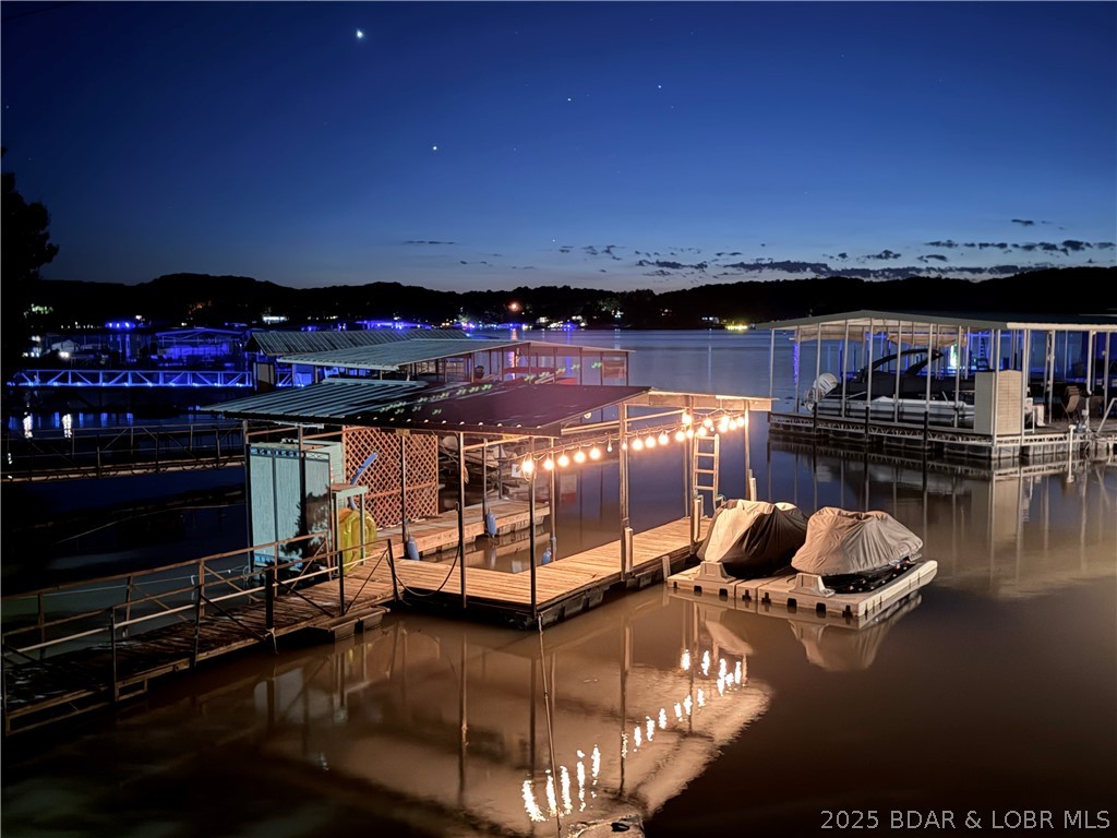 Back on the market—buyer financing fell through, giving you another opportunity to own this remodeled lakefront investment. Updated in 2023, this 4BR/3BA property at the 36 MM of the Osage Arm features a 3BR/2BA main home with panoramic sunset views, an expansive lakeside deck, a gentle walk to the private dock, private boat ramp, newer HVAC, PEX plumbing, custom cabinetry, and updated appliances. A detached 2-car garage with a 1BR/1BA apartment creates excellent flexibility for guests, owners, or additional rental income. Just minutes from popular waterfront restaurants by boat or car, it’s perfectly positioned for vacation rentals. The protected cove offers calmer water for swimming, kayaking, paddleboarding, and outstanding bass fishing right off the dock, while still providing quick access to the main channel when you’re ready for the larger lake. Whether you’re looking to maximize rental potential, enjoy weekend fishing trips, or own a turnkey lake retreat, this property checks all the boxes.