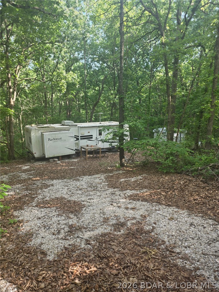 Tucked just off the pavement is this 5 acre parcel offering a peaceful wooded setting. Conveniently located near Lake of the Ozarks. Property is being sold with a camper, generator and shed. Utilities nearby.