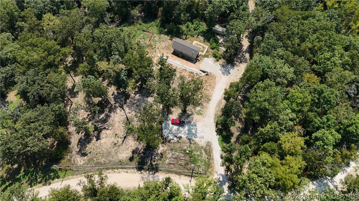 Welcome to 140 Bunker Road in Eldon, Missouri! Discover affordable country living with this charming 1-bedroom, 1-bath home situated on 5 private acres in Miller County. Offering 640 square feet of comfortable living space, the home features an open-concept layout, hardwood floors, a cozy wood stove, washer and dryer hookups, and 200-amp electrical service. Ready to add a garage or workshop? A level 30' x 40' building site is already prepared with water plumbed and electrical conduit in place. Whether you’re searching for a starter home, weekend retreat, or a peaceful escape from apartment living, this property offers privacy, affordability, and room to grow. Survey is currently in progress. Don’t miss this opportunity to enjoy your own piece of the Ozarks—schedule your private showing today!