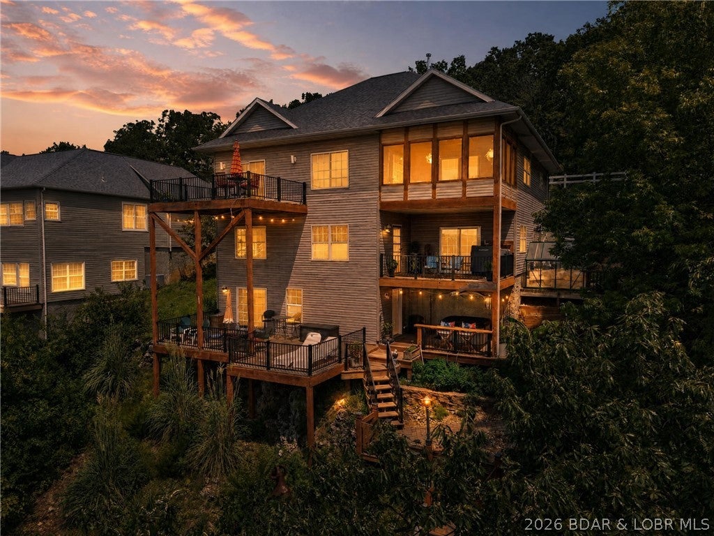 There’s a certain kind of lake house people picture when they imagine having a place where the whole family can come together—and this one was made for those weekends. Wake up to miles of Big Niangua views, grab the boat and spend the afternoon skiing, tubing or cruising the lake, then come back to a home with enough room for everyone to spread out without feeling crowded. With 4 bedrooms, 3 baths and lake views from nearly every room, family and guests can settle in comfortably while three levels of remodeled decks keep everyone connected to the reason you’re here: the water. Dinner outside, drinks in the screened three-season room, a late-night soak in the hot tub or time in the two-person sauna can all become part of the routine. Down at the water, the private concrete dock offers a 16x40 slip, two PWC slips and a 12x20 swim platform ready for full days on the lake. And when you want something beyond the water, Ha Ha Tonka’s springs, trails and natural beauty are just around the corner, with golf, dining, shopping and Camdenton nearby. Photos show the house. Walking through it while looking out over the Big Niangua is what makes this property worth seeing.