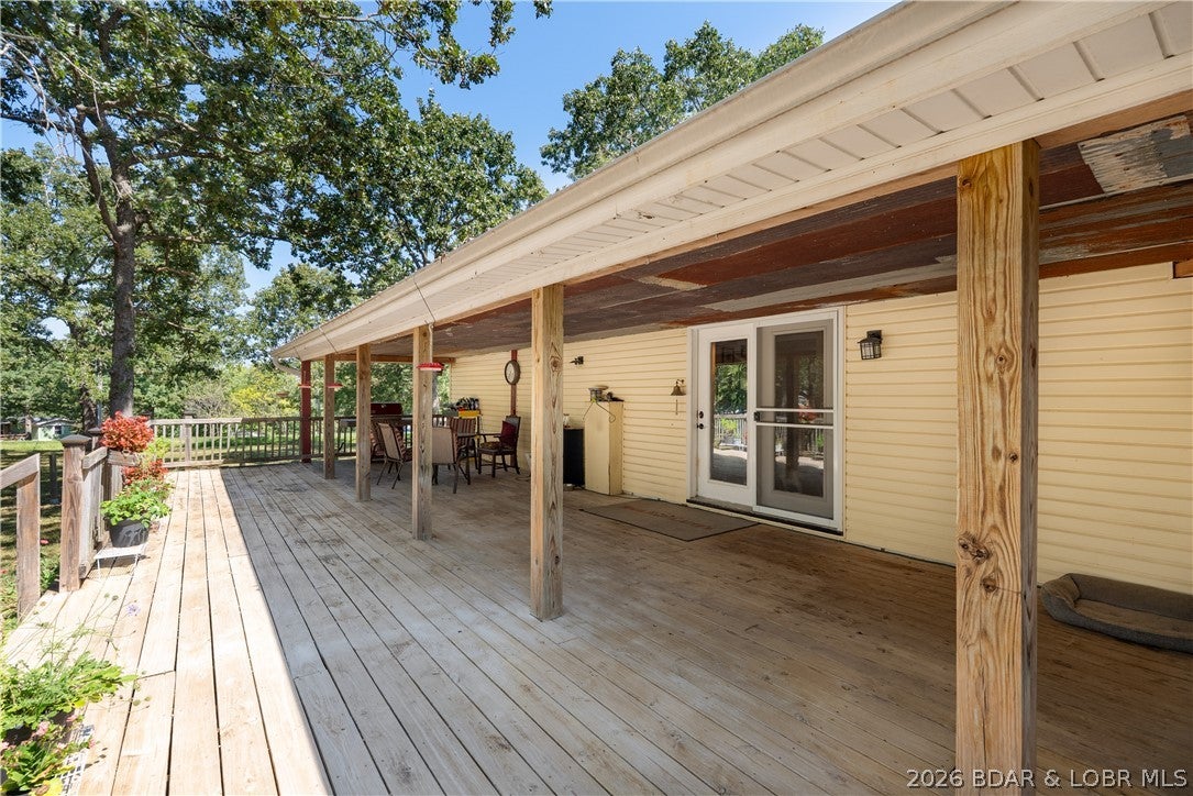 Discover the perfect blend of space, privacy, and versatility in this spacious home nestled on a small wooded acreage. Surrounded by mature trees and natural beauty, the property offers a peaceful retreat while providing plenty of room for everyday living, entertaining, and future expansion. The main level features three comfortable bedrooms and 2 full bathrooms, along with generous living spaces. A standout feature is the large covered deck, offering an inviting outdoor living area where you can relax, enjoy the wooded surroundings, or gather with friends in any season. A covered breezeway connects the home to an oversized garage, providing convenient, weather-protected access and abundant room for vehicles, equipment or storage. The lower level adds exceptional flexibility with a bonus living area, bedroom, and full bathroom, plus space already planned for a future kitchen, for an opportunity for a private guest suite, extended-family quarters, recreation space, or a potential secondary living arrangement. With wooded acreage, versatile living space, an oversized garage, and room to customize and expand, this property offers a rare combination of comfort, privacy, and potential.