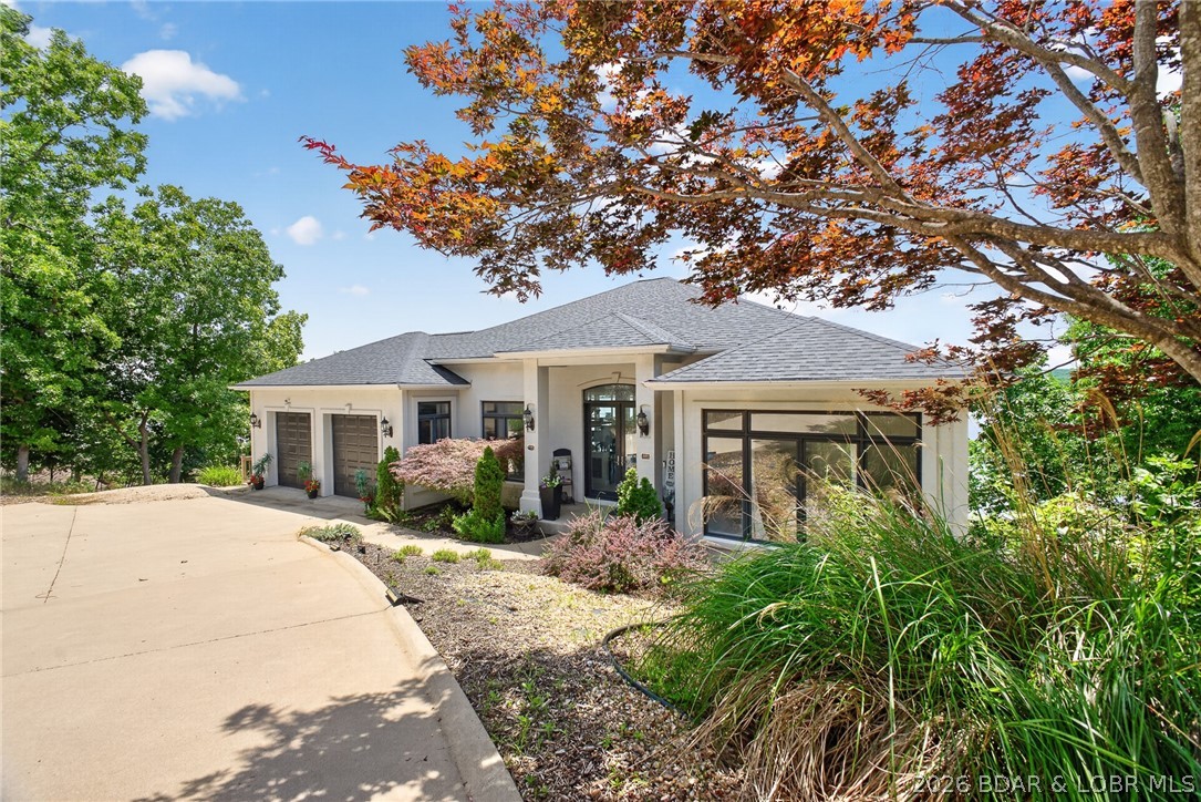 Lakefront, luxury, effortless are the best describing words for this incredible Four Seasons retreat here at Lake of the Ozarks. Featuring 4,800+ sqft, 5 bedroom, 3.5 bath, dual living rooms, game room, wet bar and breathtaking panoramic main channel views of the Lake. As you step foot inside the 10 Mile Marker views of Lake of the Ozarks bring you out to the deck where you want to sit, soak up the sun & watch the boats go by. The upper level features open kitchen, primary lakefront bedroom suite, expansive bathroom & walk in closet and guest bedroom. Heading downstairs to the lower level is where the fun begins. 10 ft ceiling heights, Dolby surround sound, 4K HDR projection theater experience, game room, wet bar this home is set to entertain. Whether hosting game days, moving nights or unforgettable gatherings this space was designed to impress. Step outside and experience lakefront living. Multiple levels of outdoor deck space, private hot tub overlook and spectacular views of Lake of the Ozarks. Schedule your private showing of this home today and experience this exceptional lakefront lifestyle for yourself.