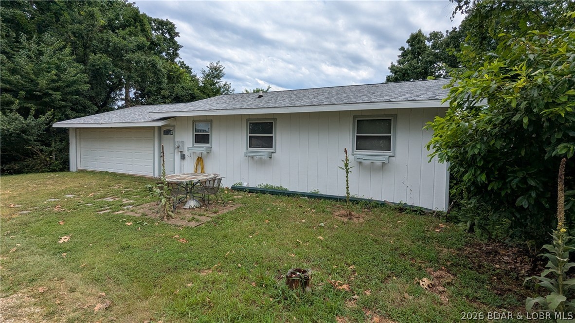 This beautiful established home is located on a quiet road at the Lake of the Ozarks, Missouri.  It has a filtered lake view and is the setting for this nicely redone lake getaway oasis. And a bonus is a double-car garage that is attached (so lots of room for storage). Many upgrades have been done- new flooring, paint, 2 new bathrooms- the roof is only 2 years old. There is a whirlpool tub for relaxing, and both levels of decking have been replaced. Many new windows and a new lower-level door help with utilities. Lakefrontage is located below the subdivision on 5 acres of hillside that ends in a cove. A dock could be put in, as it has 200 ft of lakefront that belongs to the subdivision and can be used by anyone in the subdivision.