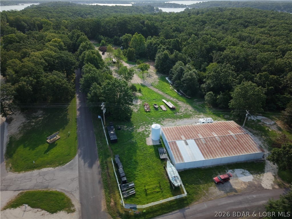 Exceptional **9.93-acre commercial opportunity** with **700+ feet of P Road frontage** directly across from Mermaid Cove Campground & Marina. This mostly level, mostly cleared, and mostly fenced property is ready for development with **electric, a private well, multiple RV hookups, and a storage building** already in place. The **Gravois Arm Sewer District is expected to extend sewer service past the property within weeks**, adding even more value and future potential. A seasonal view of Lake of the Ozarks and excellent visibility make this an outstanding location for an RV park, boat storage, contractor headquarters, self-storage, retail, warehouse, cabins, or another commercial venture. Existing infrastructure means less time preparing the site and more time bringing your vision to life. Rarely does a property with this combination of location, utilities, frontage, and development potential become available.