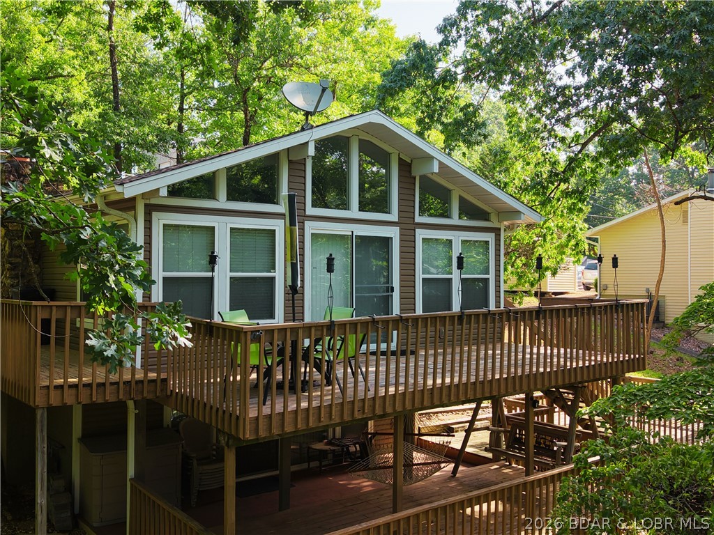 Finding a lakefront property with both great water access and usable land isn't easy. This 3-bedroom, 2-bath Sunrise Beach home delivers both. Situated on over an acre at the 10 Mile Marker, just around the corner from Frankie & Louie's, it sits in a protected cove with quick access to the main lake. Multiple decks overlook the cove, creating the perfect place to relax after a day on the water. The private 1-well dock features a boat lift, PWC lift, and swim platform, making lake days effortless. A large, level area at the top of the paved circular driveway offers space for boat or RV storage, extra parking, or the opportunity to build a detached shop. Inside, two stunning stone fireplaces—one gas and one wood-burning—add warmth and character for year-round enjoyment. Whether you're looking for a full-time residence, weekend retreat, or investment, this property combines location, protected water, outdoor living, and usable acreage in one exceptional package.