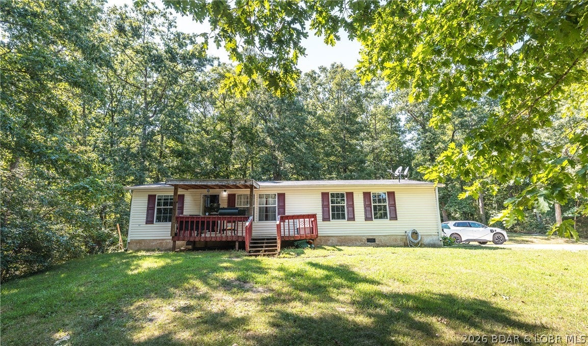Located between Eldon & Lake Ozark off of Highway 54 in a PRIME location! Enjoy the space, privacy, and flexibility of 3.20 Acres in the highly desirable School of the Osage district! This well-maintained 3 Bed, 2 Bath Manufactured Home offers comfortable living with several important updates already completed, including newer LVP flooring, kitchen appliances, a newer furnace, and a new water heater. Affixed to the property in 2018, this home provides a great opportunity for those looking for acreage without sacrificing convenience and making financing a breeze. Outside, you'll find plenty of space to build a garage, shop, or additional outdoor amenities AND a storm shelter for extra piece of mind during those Missouri storms! Several 4-wheeler trails through the woods making everyday a new adventure! Whether you're looking for a place to call home, room to spread out, or land with future possibilities, this property is worth a look!