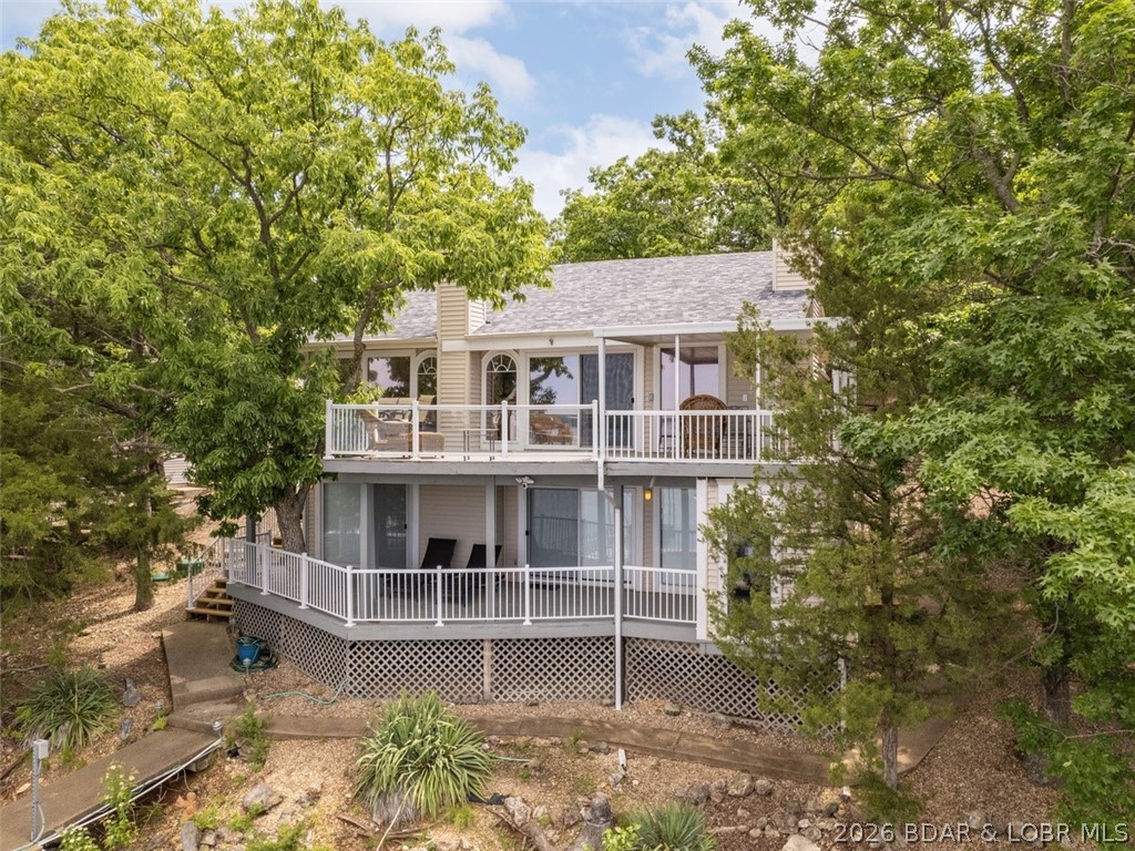 Overlooking the the gorgeous Lake nestled in a cove at the 3.5 MM & a home that shows like a display is the beginning of an exciting adventure at the Gorgeous Lake of the Ozarks. This property has updates including HVAC & state-of-the-art septic system, newer roof, updated electrical, lights controlled via WiFi, & a beautifully renovated kitchen with newer countertops, backsplash, stainless appliances & cabinets, attached two-car garage with a newer garage door/motor & electronic deadbolts offering added security & safety. New reinforcements on the dock's stiff arm & walkway along with 5/8 iron cables that will allow reduced maintenance to the large, 2-well dock. 91' LF and views are incredible in almost every room, beautiful wood floors, open floor plan, large archway windows, high vaulted ceilings, warm colors, beautiful decor, upper and lower fire, large tile floors, places parklike setting, 92 feet of waterfront, large concrete dock, extended rooftop for large boats, & swim platform. This home is in one of the most popular areas at the lake. This home is a great vacation rental or enjoy your own private Lakefront living. View 3587928 for another great Lakefront vacation rental.