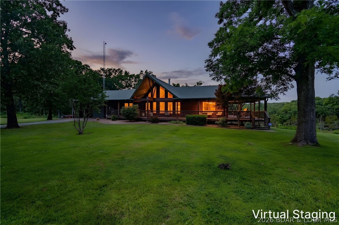 Luxury, privacy, and recreation come together on this incredible 5-bedroom, 4-bath estate on 84+/- acres overlooking a large private lake. With over 4,000 square feet of living space, the home features oak flooring, granite countertops, cathedral ceilings, Anderson windows, a wood-burning fireplace, three master suites, a walk-in tile shower, hot tub, and a brand-new whole-home generator. Outside, enjoy a heated saltwater pool, massive patio, stone outdoor fireplace, and approximately 1,700 square feet of covered porch space. The property also includes a beautiful covered dock on the private lake, a private pond, and an RV site with utility hookups. The impressive 4,100-square-foot insulated shop features 200-amp service, oversized doors, and a 64x44 lean-to, while a 34x24 storm shelter provides added peace of mind. Located on blacktop frontage with a Truman Lake boat ramp at the end of the road, this one-of-a-kind property offers the perfect blend of luxury living, outdoor recreation, and unmatched functionality.