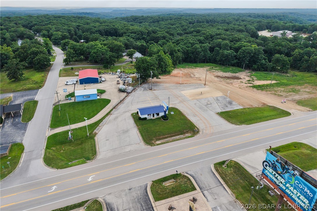 Unique opportunity to own 5.83 acres of commercial property on Highway 5 in the heart of Laurie. This versatile property features two level lots already cleared and ready for development, with the remaining acreage easily developable for future expansion. An existing commercial building, currently operating as a nail salon, has been updated with new flooring and fresh paint, providing immediate rental income or a turnkey space for your own business. Whether you're envisioning retail, office space, storage units, a restaurant, laundromat, gas station, or another commercial venture, this property offers the flexibility to bring your vision to life. With excellent Highway 5 frontage and endless possibilities, this is a property you won't want to miss.