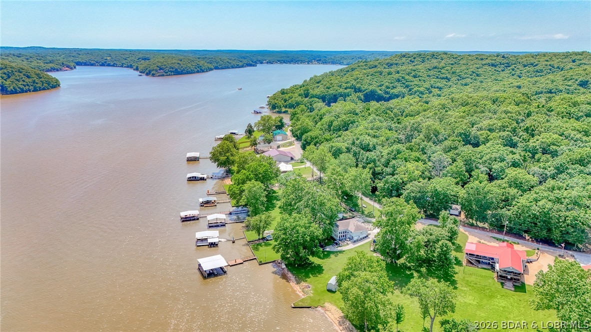 This is your chance to own your dream home (5 bedrooms and 2 bathrooms) on Lake of the Ozarks on MM 73 and approx. 240' of lake front!! So many features you'll love and updates made by the seller including: new HVAC in 2025, new hot water heater in 2025, complete remodel in 2013 including the brand new formal living room addition and added two bedrooms, the mini splits were added in 2013, new driveways in 2013, the lift added in 2013 and custom cabinetry added in 2013. Relax outside- watching the boats go by on your dock with 2 slips and 1 lift. Outdoor space is everything with large patio, firepit and gorgeous property!! The home will be sold furnished. This one is a must see on your list!!!