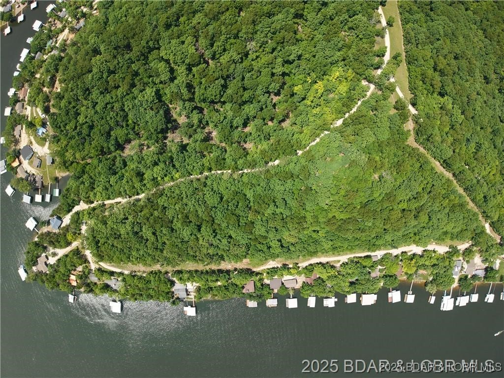 Incredible 10-acre property located on the 6MM of the Gravois Arm at Lake of the Ozarks in Barnett, MO, offering a rare combination of expansive second-tier acreage and development potential. With flexible purchase options, this property can be sold as a whole or divided in multiple ways to suit your vision. Whether you’re looking to build a private estate, a family compound, or a residential development, this property offers endless potential in a peaceful, desirable location.