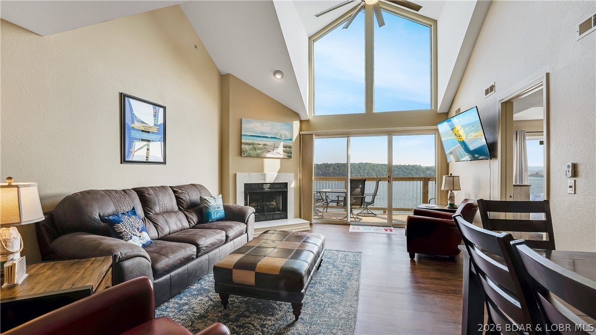 TOP-FLOOR PANORAMIC MAIN CHANNEL VIEWS set this exceptional two-level condo apart in The Ledges – Building 10. Designed to impress, the voluminous open floorplan is anchored by soaring two-story windows that flood the living space with natural light and frame unobstructed views of the main channel at the 21-mile marker. Step directly onto the new deck to take in the lake action and unforgettable sunsets. The main level offers a generous dining area, kitchen with eat-at bar, and a tranquil lakeside primary suite with deck access and a spacious en-suite bath. A guest bedroom, full bath, and laundry with full-size units complete this level for everyday comfort. Upstairs, the loft-style third bedroom overlooks the dramatic lakeview windows and includes bonus living space—ideal for guests, kids, or additional lounging. (add a wall to create separation easily). One of the lake’s most sought-after and family-friendly communities, The Ledges features a sand beach, interior community pool, and a stunning point pool with bar area for enjoying the lake in style. Whether for personal enjoyment or investment potential, this top-floor retreat delivers. 10x30 slip included.