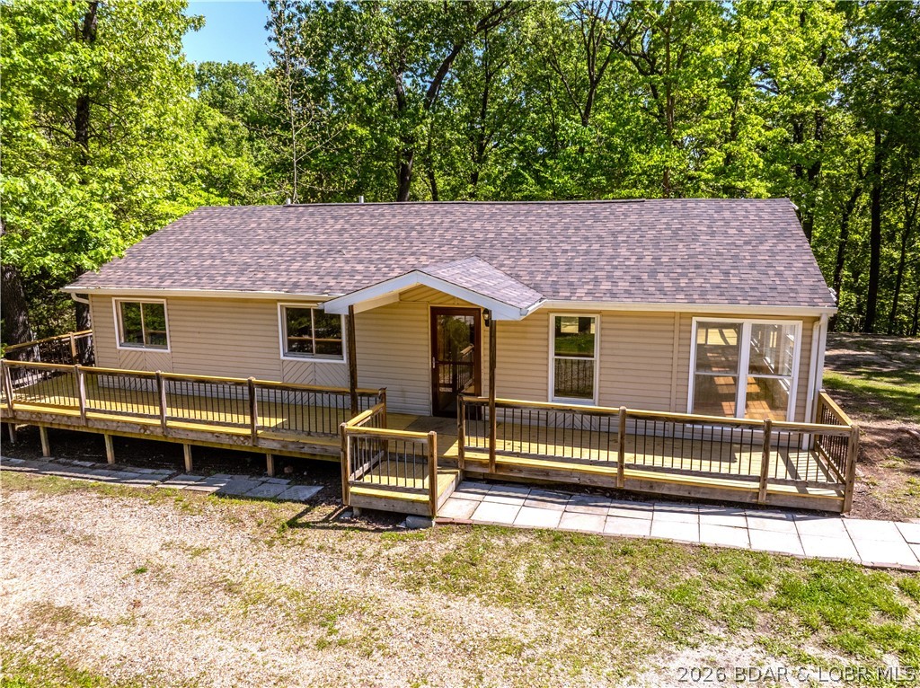 Completely remodeled and move-in ready, this Rocky Mount home offers the perfect blend of quality upgrades, functional living & a great location—just 10 minutes from the Bagnell Dam Strip and 15 minutes to Osage Beach. This 3bed/3bath, approx. 1,700 sqft home features main level living with vaulted ceilings, abundant natural light & a spacious sunroom off the living room. One of the standout features is the newly rebuilt oversized deck off the back of the home that wraps around to the front, creating excellent outdoor living space. Major upgrades include a new roof, heat pump HVAC, new 1,000 gal septic tank, remodeled kitchen with new appliances, fresh paint, updated fixtures, relocated electric panel, multiple new windows & new crawlspace vapor barrier. Primary suite includes a private bath with walk-in shower & soaking tub. Exterior offers a flat backyard, circle driveway & additional space beside the home ideal for a future shop or garage. A rare turn-key opportunity with extensive improvements already completed!