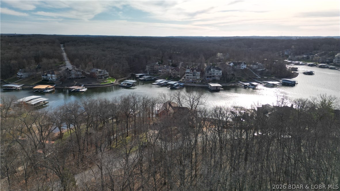 Grand views await on Grand View Drive in the prestigious Porta Cima community at Lake of the Ozarks. This moderately sloped, second-tier homesite offers 139 feet of road frontage and beautiful year-round lake views, creating an exceptional setting to design and build your custom lake home. The topography provides an excellent building site with potential for a walkout-style design, ideal for maximizing lake views and outdoor living spaces. Porta Cima—meaning “hilltop by the harbor”—perfectly reflects the elevated lifestyle found in this premier lake and golf community. Enjoy access to the 18-hole Jack Nicklaus Signature Golf Course along with outstanding amenities including the private Porta Cima Yacht Club, marina and a vibrant calendar of social gatherings. Ownership also includes access to Four Seasons amenities offering indoor and outdoor pools, playgrounds, boat launches, trailer storage, campground, and more. The perfect blend of luxury golf, scenic lake views, and relaxed lakeside living in one of Central Missouri’s most sought-after communities. Bring your vision and build the lake home you’ve always imagined!