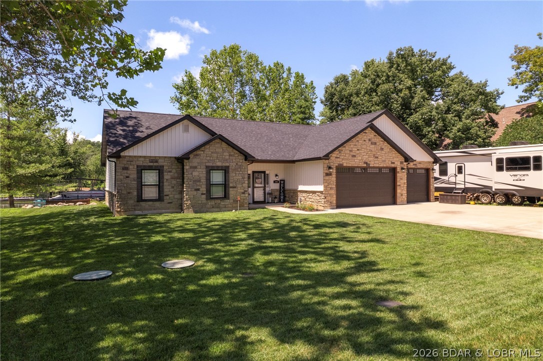 Enjoy easy lakefront living in this beautifully maintained newer ranch home nestled in a quiet, protected cove. Featuring one-level living, a flat driveway, and a gentle walk to the water, this move-in-ready home offers everything you've been searching for. The inviting lakeside screened deck is perfect for relaxing or entertaining, while the lakeside patio with a stunning fire pit creates the ideal gathering space. Just a few easy steps lead to your 12x34 boat slip, making time on the lake effortless. You'll also appreciate the 3-car garage, ample parking, and a convenient bathroom with direct garage access. Located in a rare lakefront community with central water and sewer, this home combines comfort and convenience. Need a larger slip? A 16x34 boat slip is also available for purchase for $25,000. Don't miss this exceptional opportunity to own your lakefront dream!