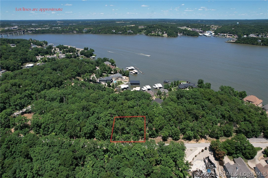 Extremely nice buildable lot in Porto Cima with access from two blacktop roads making it ideal for a two story, walkout basement  home.  A slight rise in the topo from the upper road of Quanta Grande makes for a perfect "front" door with a gentle fall towards Via Cresta Drive for walkout.  Gentle enough for a large one level home as well.  Porto Cima is a lovely community with a great full time population, close to the reknowned Jack Nicklas golf course, private clubhouse, pool and marina.  Also available are all the amenities of the Four Seasons POA with multiple pools, indoor and outdoor, clubhouse, launch ramps, fishing lakes, playgrounds, walking and biking trails.  Great information about the community as well as building restrictions, Dec of Restrictions, Builders Guide at http://FourSeasonsPOA.com. (Password is: FourSeasonsPOA2025).