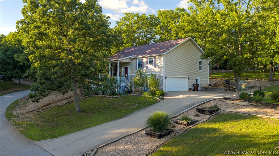 Located in the sought-after Camelot Estates community, this spacious 3-bedroom, 2.5-bath home offers comfortable living, outstanding amenities, and a versatile floor plan. The open-concept main level features vaulted ceilings, abundant natural light, hardwood flooring, a cozy fireplace, and a spacious kitchen with ample cabinetry, pantry, breakfast bar seating, and an adjoining formal dining area. Upstairs, the primary suite includes a walk-in closet and private bath with a jetted tub and walk-in shower, while two additional bedrooms and a full bath provide privacy for family and guests. The finished lower level offers a large family room, half bath, and laundry area. This home has also been upgraded with a new water purification system, new frig & double- oven gas stove. Enjoy your morning coffee from the covered front porch or unwind on the back patio. An oversized 2-car garage and additional parking areas on both sides of the home provide plenty of room for guests. Camelot Estates amenities include community pools, clubhouses, tennis courts, campground, boat ramp, horse stables, and lake access, allowing you to enjoy the Lake lifestyle without the upkeep of waterfront property.