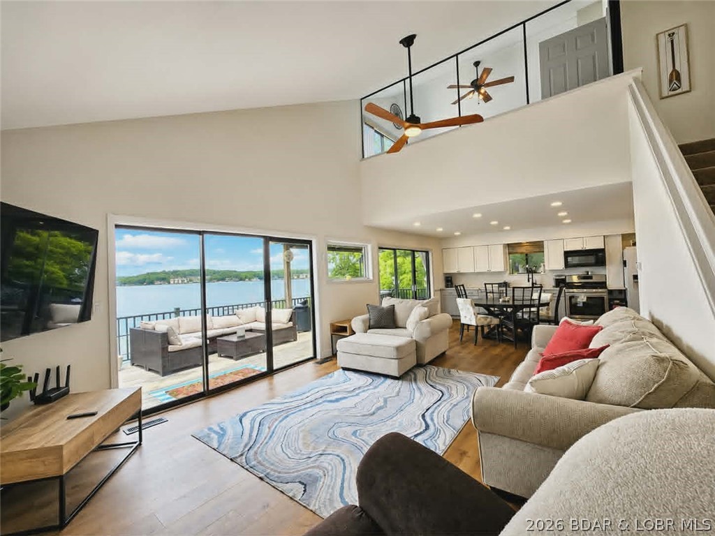 Step inside to vaulted ceilings and a stunning primary suite overlooking the living area through a dramatic half-glass wall. From the moment you enter, you'll be captivated by the breathtaking main channel views that can be enjoyed throughout the home. There is room to sleep all the family and friends in this 5 bedroom and 4 bath home. Recent updates including beautiful new kitchen cabinetry, luxury vinyl plank flooring, and new carpet. If your wish list includes spectacular lake views, plenty of outdoor entertaining space, ample parking, a large dock with that hard to find large 16' x 42' boat slip, 200 feet of deep-water, a moderate lot, NO HOA, and located at the 10MM close to restaurants, shopping, and lake attractions, A second-tier lot is also included, providing additional parking or the perfect place to build a garage or workshop. For investors or those looking for a multi-family opportunity, the neighboring property is also available (MLS #3586847 or MLS #3587914), creating the potential to own two adjoining lakefront properties. Don't miss this rare opportunity—schedule your private showing today before someone else makes it theirs!