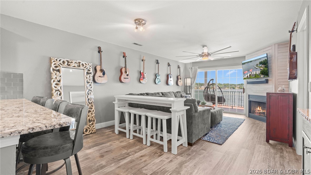 Experience luxury lake living at its finest in this professionally decorated, fully furnished end-unit condo at Harbour Bay Condos in Sunrise Beach. Nestled in the prestigious Porto Cima/Villages area, this beautifully remodeled residence features a bright, open floor plan highlighting a million-dollar panoramic view of the 19-mile marker. Exceptional upgrades abound, including a custom built-in wet bar, a cozy corner gas fireplace, and a light-filled kitchen with an eat-in bar. The lakefront master suite offers a private sanctuary complete with a walk-in closet, while ample guest sleeping space includes a queen sleeper sofa.

Step outside onto your spacious private deck, complete with dedicated storage, to enjoy the scenery. Your investment is protected by a premium wave break, ensuring calmer waters for the included 14x40 boat slip and PWC lift. The complex features a main-channel view swimming pool, new landscaping, and updated retaining walls and docks. Best of all, short-term rentals are not allowed, guaranteeing a peaceful, quiet gated community environment. Conveniently located by both land and water, this pristine condo truly stands head and shoulders above the rest.