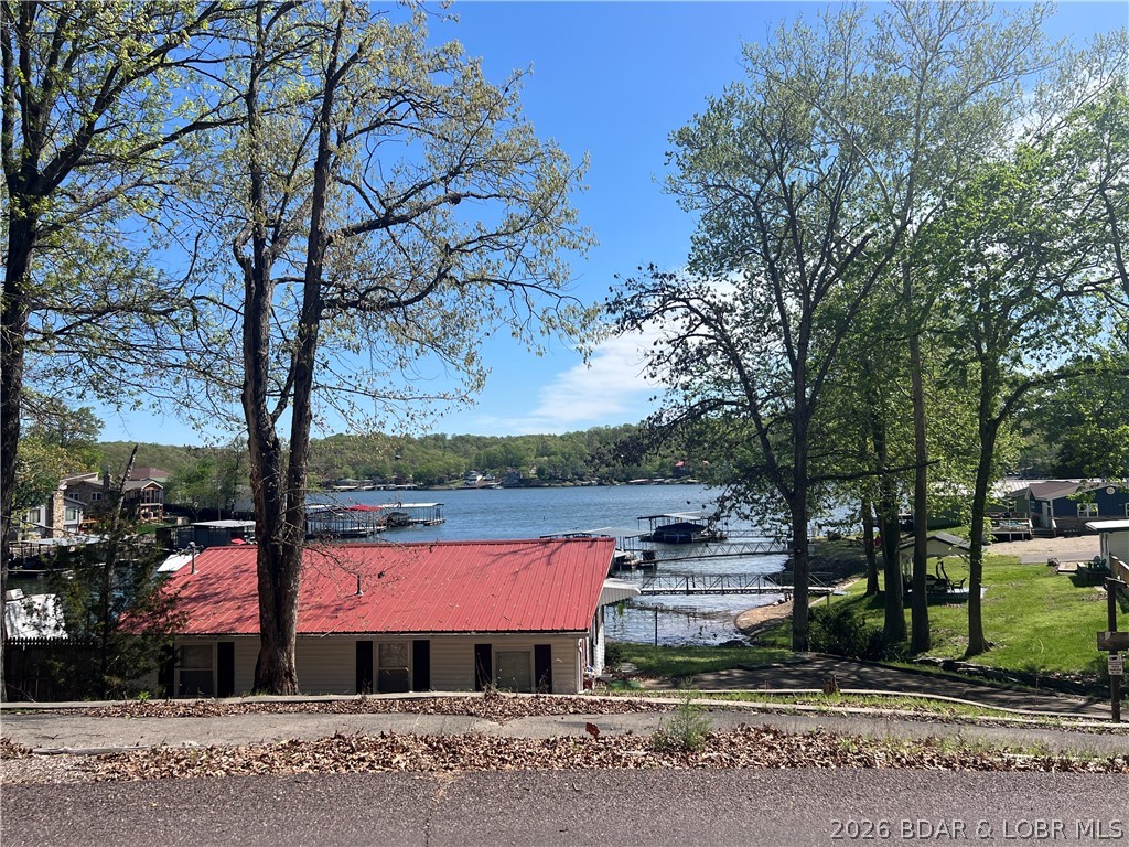 Imagine waking up to lake views every morning — and making them permanently yours. These 4 wooded lots, totaling just under 10 acres, offer a rare opportunity to build your dream lake retreat in one of Missouri's most beloved destinations. With stunning views of the Lake of the Ozarks and situated on the 2nd tier from the water, you'll enjoy the beauty and tranquility of mature trees without sacrificing convenience — lake access, marinas, dining, and entertainment are all just seconds away. The largest lot spans 7+ acres, giving you incredible privacy and room to breathe, while the 3 adjoining lots open up a world of possibilities: build multiple homes, create the ultimate family compound, or simply enjoy the extra space. The flexibility here is truly unmatched. No HOA. No fees. Just 10 acres of potential on all four lots sold together. Whether you're dreaming of a vacation getaway, a full-time residence, or a smart investment in a high-demand lake community, this one is worth a serious look. Opportunities like this don't come around often at the Lake of the Ozarks!