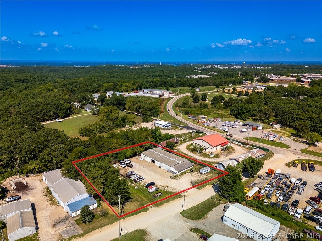 Space, flexibility, and a convenient Osage Beach location make this commercial property one to consider. Located just off Highway 42 within Osage Beach city limits, the approximately 5,000 sq ft building sits on a large fenced lot with ample parking and offers a layout that can accommodate a variety of business needs. The property features two large bays plus an additional heated bay, seven separate office spaces, a full kitchen area, 2.5 bathrooms, and a spacious loft for additional storage or workspace. If purchasing and you don't need the heated bay with storage rooms, the seller will convert that area back to open warehouse space at their expense. Zoned C-1 with city water and sewer, this property offers plenty of options for an owner-user, expanding business, or investor. Equipped with 120/240V single-phase electrical service, perfectly suited for retail, professional office space, or light commercial use.

Also available for lease at $3,000/month. MLS 3589724