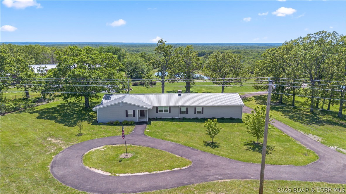 Whether you're looking for a serene homestead, an investment opportunity, or both, this one-of-a-kind property delivers space, versatility, and stunning natural beauty. Endless possibilities meet peaceful country living here. Set on approx. 12 park-like acres, this exceptional 4-bedroom, 2-bathroom home offers the perfect blend of privacy, space, and income potential. Surrounded by breathtaking, sprawling countryside views, the property features a private lake—ideal for quiet mornings, fishing, or simply enjoying the scenery. You'll look forward to spending time out in your garden gathering the fruits of your labor. 

The home offers comfortable living and plenty of room for family or guests, plus a 2-car garage. Beyond the residence, the opportunities truly expand. A massive 9,900 square foot outbuilding is perfectly suited for boat or RV storage, making it an excellent option for generating rental income. There is even an RV park on the property that includes water, sewer, electric hookups, and a shower facility—creating additional revenue potential or a welcoming setup for extended visitors.

Come live the lifestyle—and the opportunity—you’ve been waiting for.