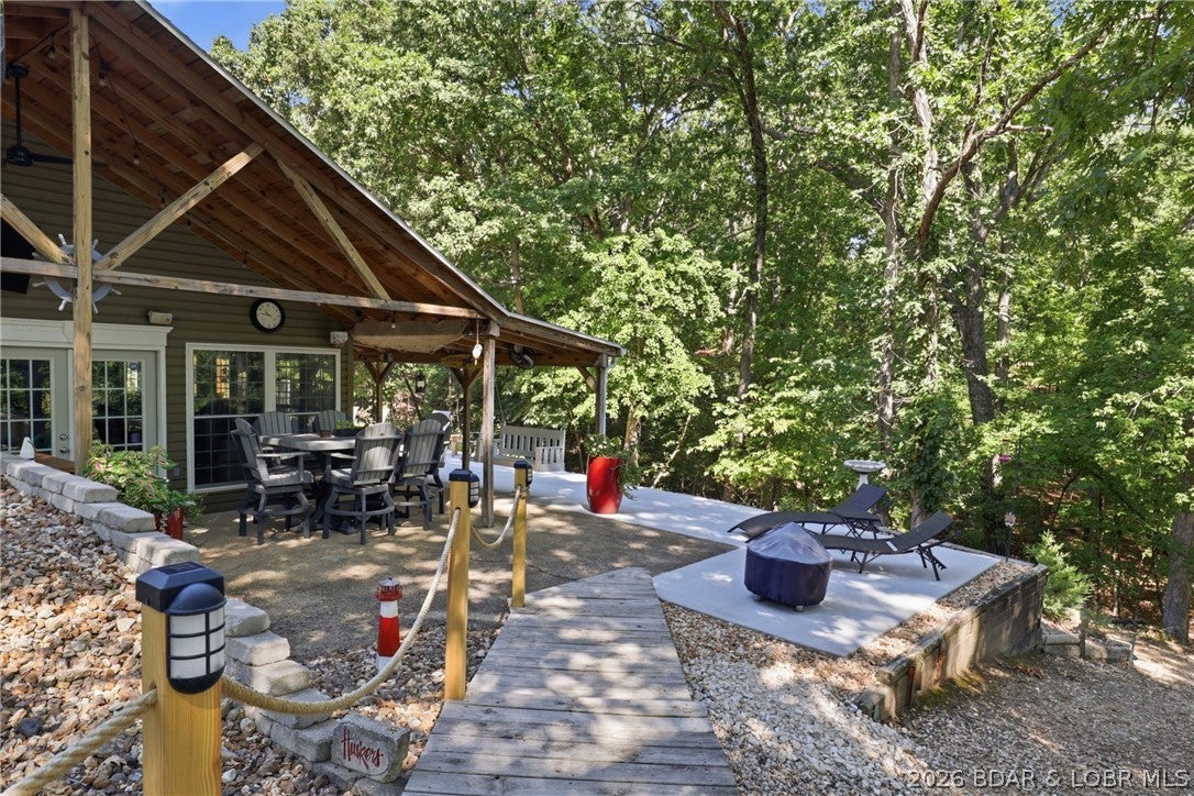 Welcome to the peaceful Sedalia Boat Club, a quiet lakeside community located at the Forked Hollow Cove at the 13-mile marker in Sunrise Beach.  This second-tier home offers a lake view along with access to desirable community amenities, including a boat/pwc dock, boat ramp, trailer parking and a charming old-school bathhouse and a community pavilion. This home features modern upgraded amenities merged with an amazing outdoor living space for a peaceful expience all while being close to attractions in Lake Ozark, Osage Beach, and surrounding areas.  Whether you’re looking for a full-time residence, weekend retreat or vacation property, this home provides an inviting opportunity to enjoy the Lake of the Ozarks lifestyle away from the congestion of the more commercialized areas.