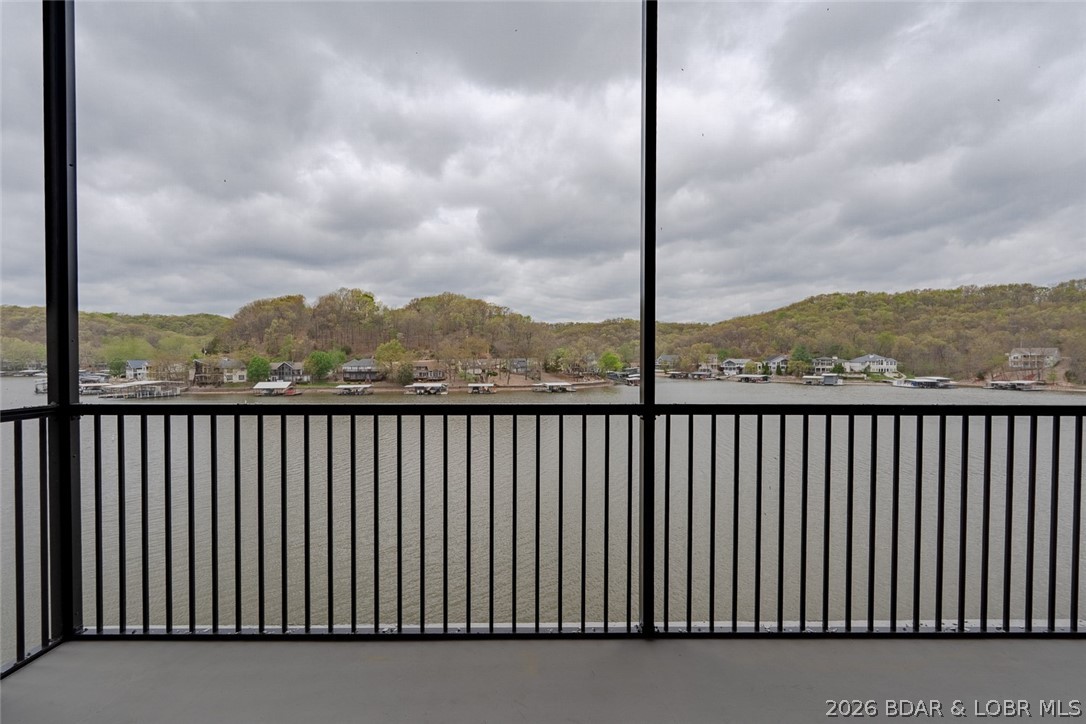 Top-floor living at its best. This Ember Ridge condo features 24’ ceilings and breathtaking lake views that truly set it apart. Located just steps from the elevator, this unit offers both convenience and a sense of exclusivity. The open-concept layout is designed for entertaining and everyday comfort, complete with 3 full bathrooms, three large bathrooms, and a large pantry. Built with rare steel construction and finished with a clean, modern design, this brand-new condo stands out from anything else at the Lake of the Ozarks. Ideally located near several of the lake’s most popular waterfront restaurants and attractions. Dock slips and PWC slips available. Perfect as a luxury getaway or high-demand vacation rental. Photos are of Model Unit #205 and used to showcase design and finishes—you will have to see this one in person!