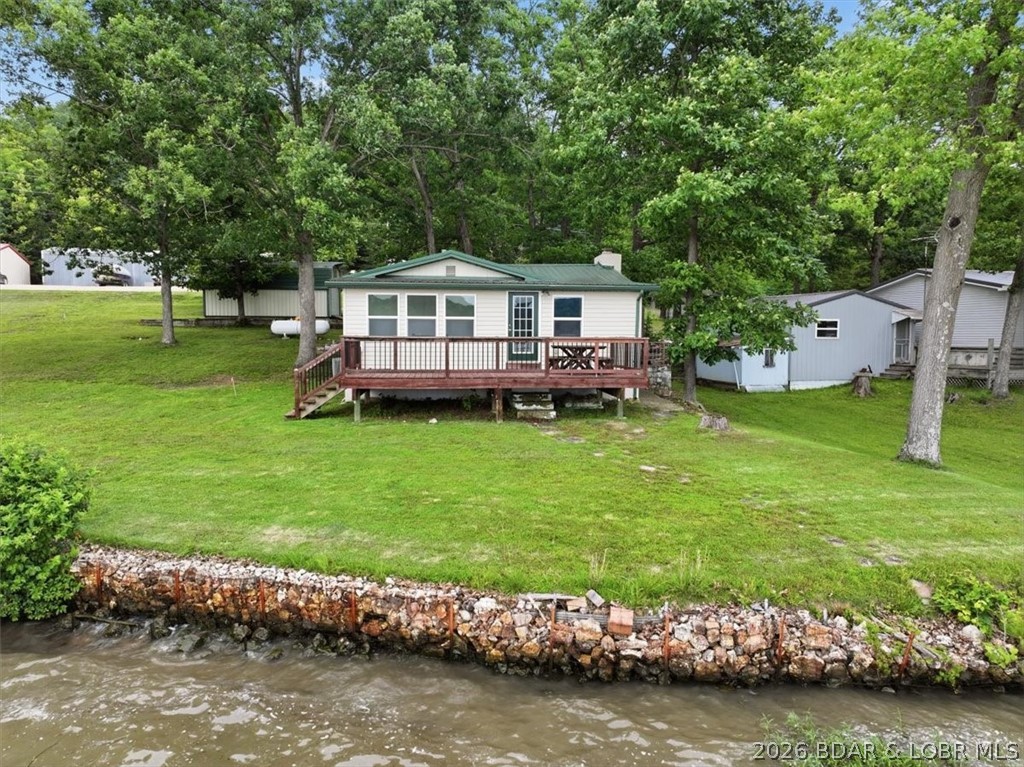 Lakefront Cabin located at the 59 MM with main chanel views. Enjoy lake life at its best with this charming 2 bedroom, 1 bath cabin. This cabin is move in ready. Wake up every morning with this beautiful panoramic vew. Relax on your nice deck lake side. Nice large lot with plenty of trees for shade with room to build a garage or nice size building. Motivated Sellers! Don't miss out on this updated cabin. You will love the wood burning fireplace on those cold evenings. Cabin has vinyl siding and metal roof, New windows through out. Septic system recently inspected and is in great working condition. Seller has inspection report.  Does not have dock, but does already have a dock permit.