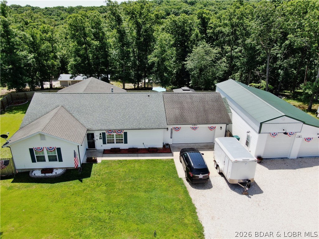 Exceptional opportunity offering versatility, functionality, and income potential all in one property. Boat slip is available for rental. This unique setup features a 1,662 sq ft main residence paired with a 1,262 sq ft shouse/shop, creating endless possibilities for multi-generational living, rental income, or live-work flexibility. The main home offers 3 bedrooms and 2 full bathrooms. Outdoor living is a standout feature of this property. Enjoy relaxing mornings or evening gatherings on the screened-in porch, offering protection from the elements. The open deck provides additional space for grilling and entertaining. Adding tremendous value is the impressive shouse/shop, complete with its own kitchen and Bathroom. This fully functional secondary living space offers incredible flexibility. Use it as guest quarters, extended family housing, rental property, private apartment, hobby space, workshop, or a home-based business location. Properties offering this level of flexibility and square footage are rare. Whether you're searching for a primary residence with income potential or a long-term investment opportunity. Explore the possibilities this unique property has to offer.