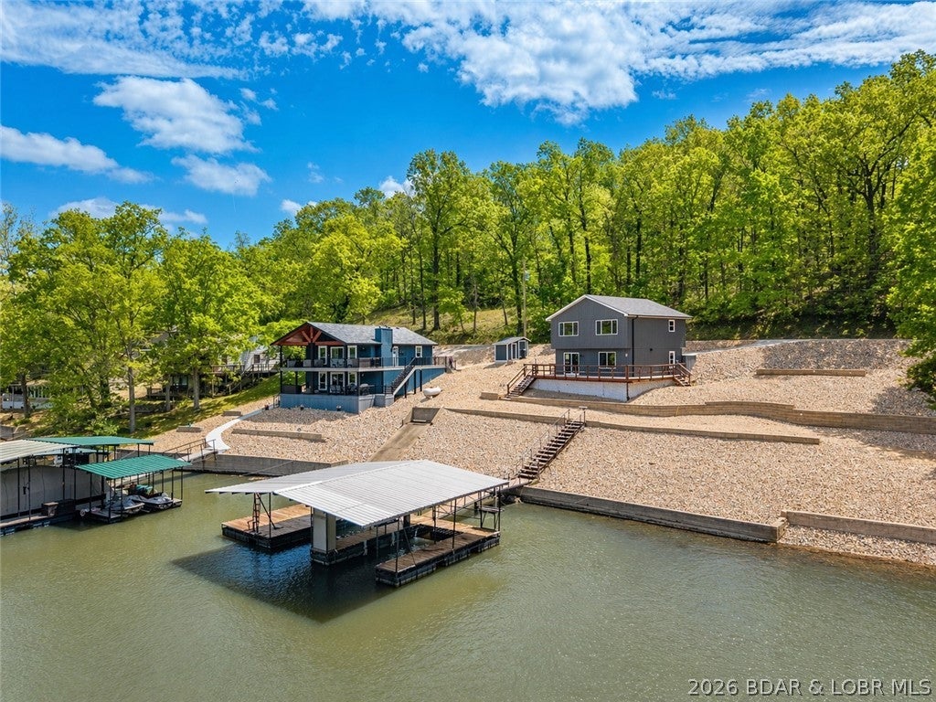 PRICED TO SELL - ALL OFFERS WELCOME! Cove location with 100 feet of lakefront, this beautifully remodeled home offers the perfect blend of privacy, functionality, and modern style. Completely updated in 2026, this 3 bedroom, 3 bath home is move-in ready and designed for easy lake living. Step inside to a stunning kitchen featuring a large island, stainless steel appliances, and high-end finishes—ideal for hosting family and friends. Master suite offers beautiful custom tiled walk in shower. The open layout flows seamlessly to a spacious deck and a flat yard area perfect for a fire pit, yard games, or relaxing evenings by the lake. Enjoy easy access to the dock, along with a larger dock envelope and room to expand. The oversized lot gives plenty of room to add a garage. NEW septic just installed. The address says it all... this home is ready for you start Relaxing at the lake!