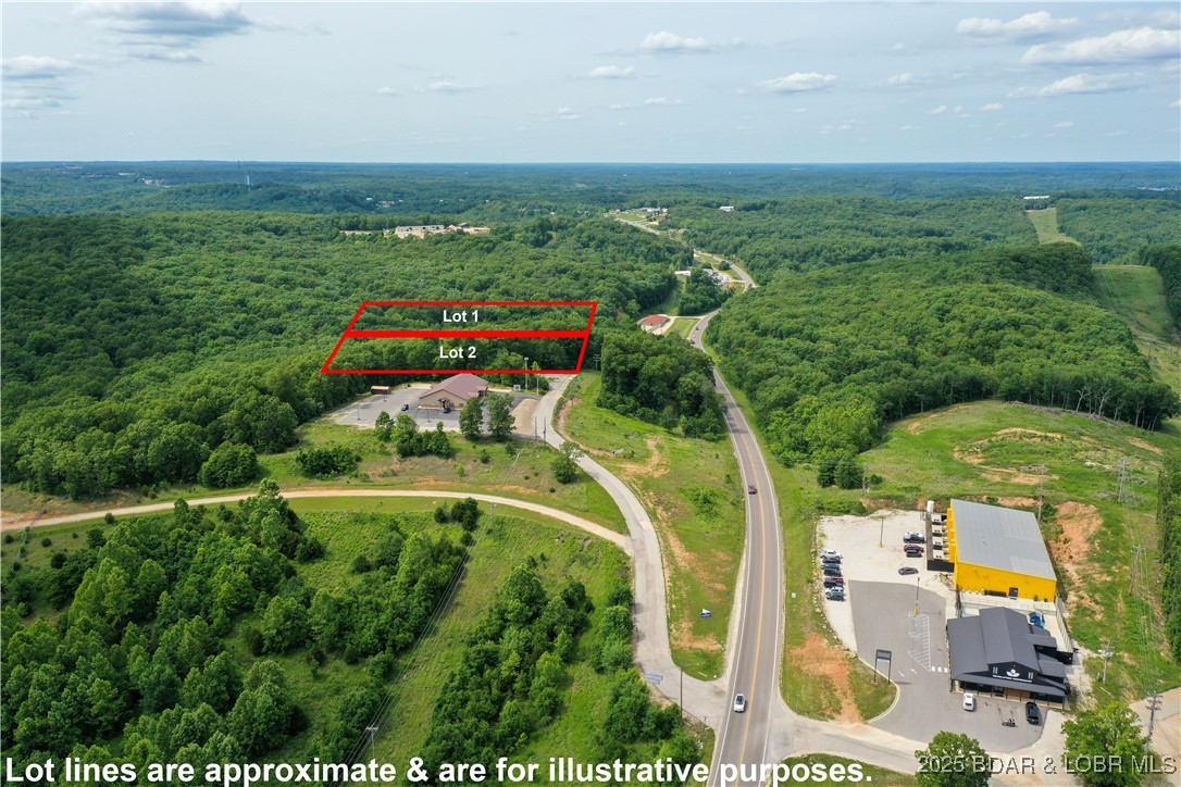 This expansive 5-acre commercial lot boasts exceptional frontage along Highway 5, ensuring prominent visibility and accessibility. Positioned in close proximity to a paved cul de sac, the location is not only convenient but also presents a myriad of possibilities for development. Situated just a stone's throw away from prominent establishments such as Woods grocery store, Frankie & Louies, and Bear Bottom Resort, the property enjoys a strategic locale that enhances its appeal. With endless options for utilization, this prime commercial lot is a promising investment opportunity in a vibrant and thriving area. Lot 2 (5 acres) next door is also available for purchase.