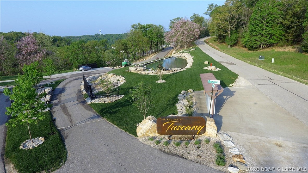 Amazing opportunity to purchase a lot with a seasonal water view in a well established subdivision. This lot will allow you to build a private home or a villa in The Villas of Tuscany Subdivision. This location is one of the most ideal lots within the subdivision. Amenities are already in place with water & sewer, internet access through Spectrum. You will enjoy the amazing pickle ball court, community pool & bath house, and golf cart path down to the community docks. Note- proposed structure shall be approved by Architecture Review Committee and landscaping will also need to be approved. (Subdivision will maintain landscaping of home, just as a Villa).