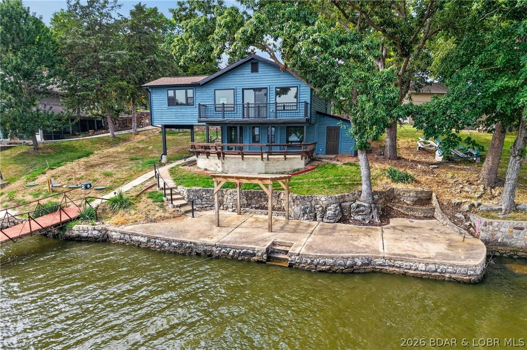 Talk about a COMPLETE OVERHAUL! This 4 bedroom 3 bath home would win the contest. Start with septic, well and roof, move onto windows, doors, drywall, flooring and paint/stain inside and out. Then add baths and all appliances including washer/dryer and lastly a new 14x14 kitchen addition with island and new mini split.
The lot is gentle with unbelievable views of the main channel and calm water just inviting you to take a swim. I love the concrete patio right on waterfront. Dock is permitted but has not been updated. Seller has had property surveyed and its ready for new owners to turn in for loma. It's a must see. COMO is active onsite.