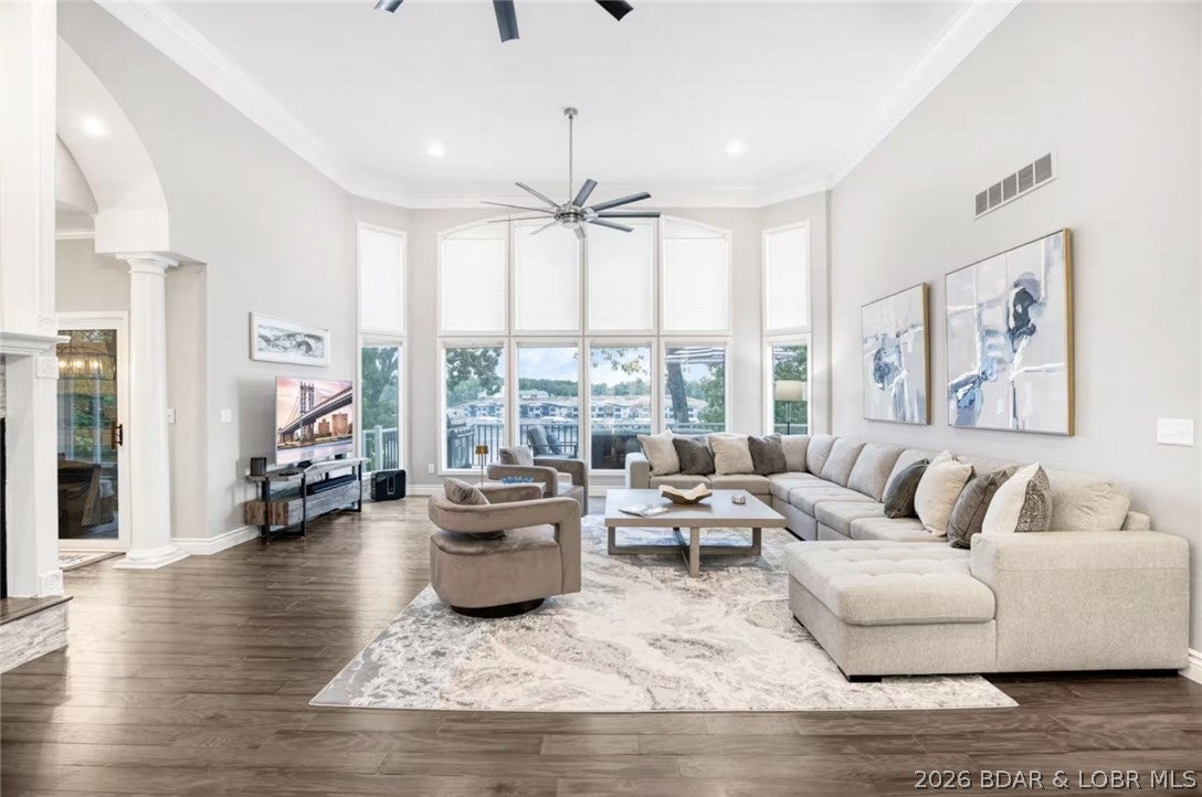 Welcome to the ultimate lakefront retreat! This beautifully renovated, cove-protected home offers 125' of private deep-water frontage & comfortably sleeps up to 20. Featuring 5 bedrooms, dual primary suites, soaring two-story ceilings, walls of glass, fireplaces, an all-seasons sunroom, lower-level living room with wet bar, & dual bunk rooms, this home was designed for entertaining. Recent updates include a modern kitchen with granite countertops, stainless steel appliances, hardwood flooring, custom marble showers, designer furnishings, & 8 TVs throughout. Outdoor living is unmatched with multiple covered & uncovered decks, fire pit, BBQs, & a spectacular 3,168 SF dock featuring 2 boat slips, 4 PWC wells, swim platform, waterslide, covered lounge, & dock bar with built-in BBQ & pizza oven. Located in prestigious Porto Cima at the 13 MM, enjoy easy access to waterfront dining, marinas, & optional country club amenities, including Jack Nicklaus golf, tennis, fitness, pool, & dining. A true turnkey luxury lakefront escape. A professionally managed short-term rental with annual gross income of $160,000 & reviews of 4.8 stars.  Easy way to defray costs when you’re not using!