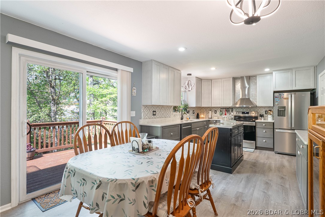 Beautifully updated and move-in ready, this 4-bedroom, 3-bath home offers the perfect blend of style, space, and convenience. The inviting open layout is designed for comfortable living and effortless entertaining. The remodeled kitchen features custom cabinetry, quartz countertops, luxury vinyl plank flooring, and easy access to the attached two-car garage. The main level includes three bedrooms and two full baths, creating a functional floor plan for a variety of lifestyles. The finished walk-out lower level offers a large family room, fourth bedroom, full bath, and flexible space for guests, a home office, or recreation area. Outside, enjoy a newly added patio, fenced low-maintenance backyard, and additional ground extending to a peaceful creek. It's the perfect setting for relaxing evenings, outdoor gatherings, or simply enjoying nature. Recent updates include a newer water heater and water softener. Conveniently located near Margaritaville, Redhead Lakeside Grill, Shorty Pants, The Oaks Golf Club, shopping, dining, and entertainment, you'll be minutes from some of the Lake area's most popular destinations. Schedule your private showing today.