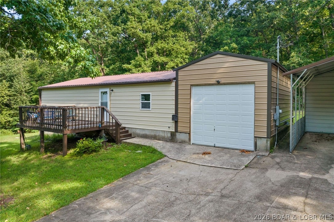 Welcome to the perfect blend of modern living and industrial utility. Built in 2022, this pristine 2-bed, 1.5-bathroom "Shouse" (Shop-House) is situated on nearly an acre of land, offering a rare sanctuary where privacy meets ultimate convenience. Located just moments from premier shopping, dining, & entertainment, this property provides a secluded feel without sacrificing accessibility. The residence is designed for durability & low maintenance, featuring high-quality metal siding, metal roof, & an inviting open deck surrounded by mature trees. Inside, the space is fresh and modern, but the true highlight lies in the expansive shop and garage facilities. A car enthusiast or mechanic’s dream, the property includes a 2-car attached garage, a 1-car detached garage, a carport, and an RV pad with full hookups. NO HOA restrictions &nearly an acre to roam, the home offers incredible expansion capabilities for those looking to grow. Whether you need a professional-grade workspace, secure storage for your lake toys, or a stylish, minimalist residence, this property delivers. Move-in ready & available now—come experience this unique lifestyle! *See rental revenue projection.