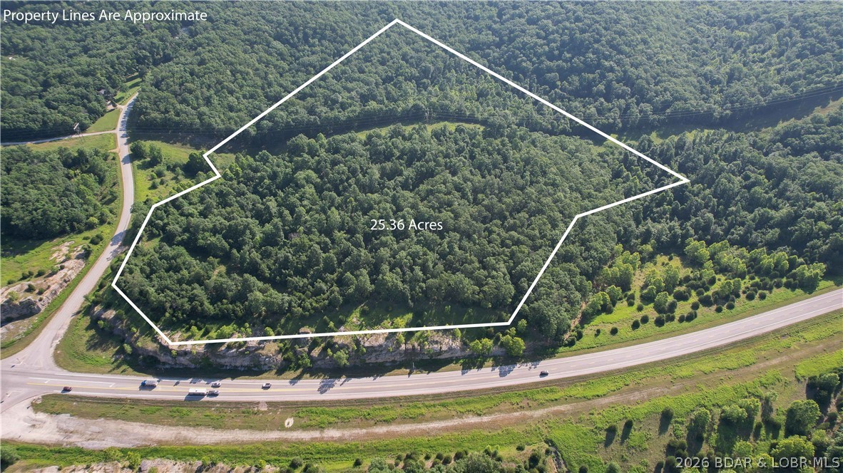 Opportunities like this don't come around often. This 25-acre tract offers approximately 1,800 feet of Highway 5 frontage in one of Camdenton's fastest-growing commercial corridors. Whether you're planning retail, office space, storage units, restaurants, hospitality, automotive, or another venture, this property gives you the visibility & location to make it happen. Just minutes from downtown Camdenton & Lake of the Ozarks, you'll benefit from strong traffic counts, excellent accessibility, & long-term growth potential. Power lines run through the property, providing nearby electrical access, while other utilities are not currently on site, giving developers flexibility to design infrastructure around their project. If you've been waiting for a large commercial tract w/ unmatched highway exposure & room to build your vision, this is one worth walking. The combination of acreage, location, & frontage is becoming increasingly difficult to find in Camden County—don't let this one get away. An exceptional opportunity for developers, investors, & business owners seeking land with excellent access, high visibility, and outstanding future appreciation potential near Lake of the Ozarks.