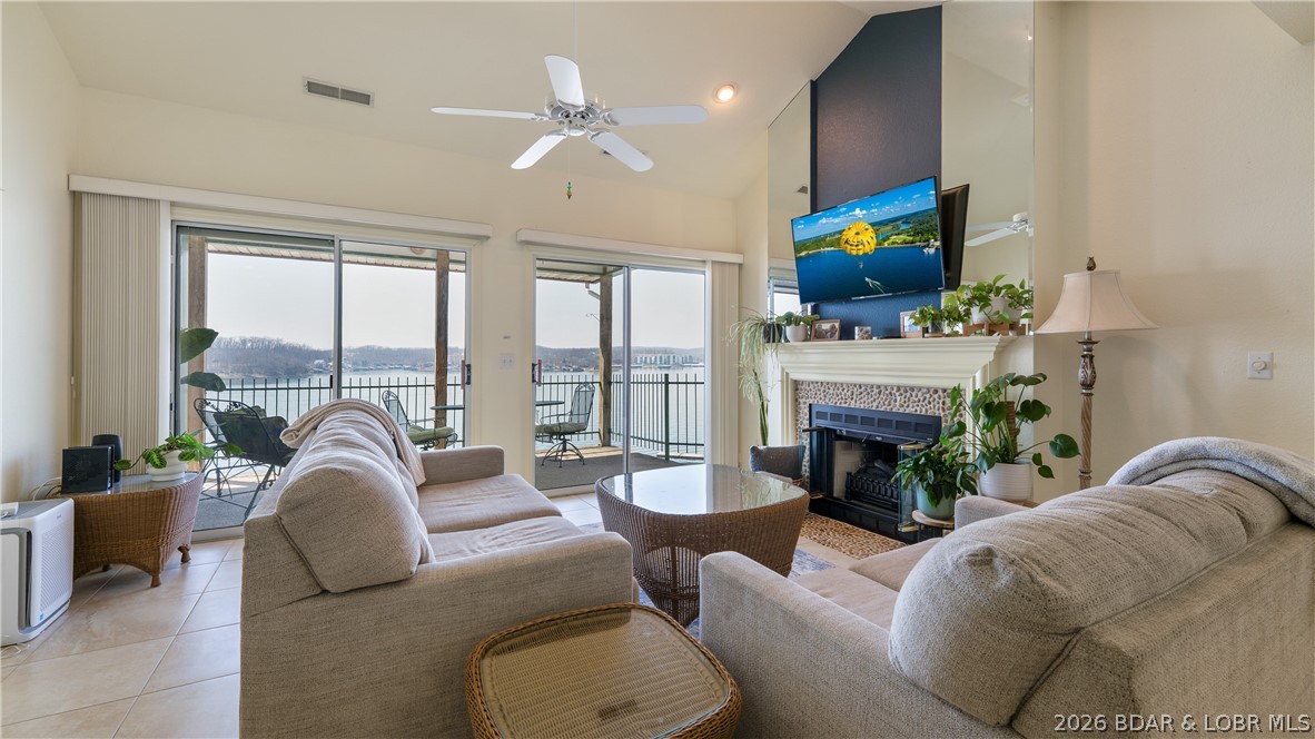 Condo life, is ALL about the view and the panoramic views at this condo, are breathtaking! That's what sets this complex apart from others. Opportunities like this are rare, with few units that offer such an expansive vantage point. This top-floor, lakefront 3 bed / 2 bath end-unit condo, features vaulted ceilings and the added benefit of no neighbors above, creating a quiet & spacious retreat. This unit comes turn-key and tastefully furnished, ready for immediate enjoyment as your personal getaway or investment property. Boating lovers will appreciate the large 14x36 slip that's included as well! Additional conveniences include an exterior storage closet and an assigned parking space located right next to the building. Community amenities include two pools, a tennis/pickleball court, exercise/workout room, lakeside boardwalk and a playground—providing something for everyone! Friendly neighbors, incredible location being right next to the Bagnell Dam Strip, front row seats to the Lake Race and the new 5 level entertainment complex next to the Dam! This is your opportunity to enjoy the lake lifestyle to the fullest!