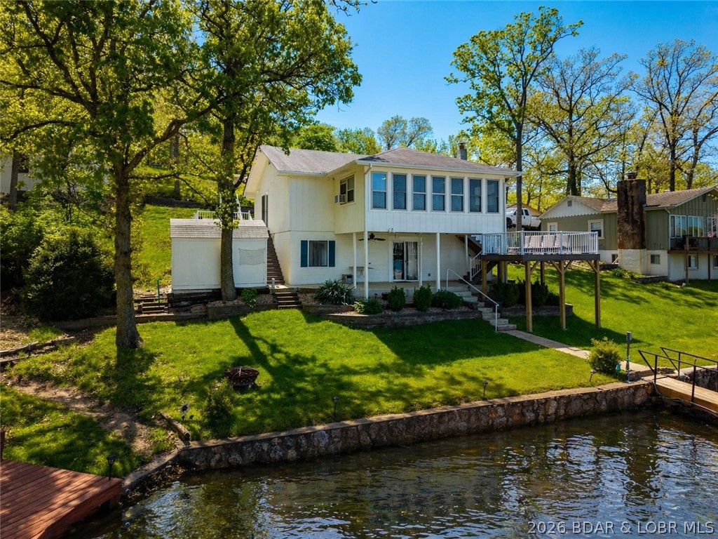 ALERT!! GOLDILOCKS PROPERTY!! With massive views, gentle & usable topography, indoor/outdoor entertaining spaces, and water that acts like cove-protected water, this gem of a home is not one you will want to scroll by! Located conveniently off of O-road, it's a hidden paradise that is not so hidden anymore! By water, this home is just around the corner from Tap & Grill, Shady Gators, Jolly Rogers, Lake Burger, and more, this home lives well on & off the water. Off water amenities include close proximity to Indian Rock golf course, Tap and Grill, and just minutes down the road from the city of Laurie, making the livability of this home phenomenal. Featuring main level living, a detached two car garage, fresh trex deckings, and additional downstairs that can double as a large ensuite, this home is sure to check off a multitude of your boxes! The memories waiting for you here are endless! Whether you are looking to utilize this property as a vacation destination or for easily captured rental income, this home is ready for you!