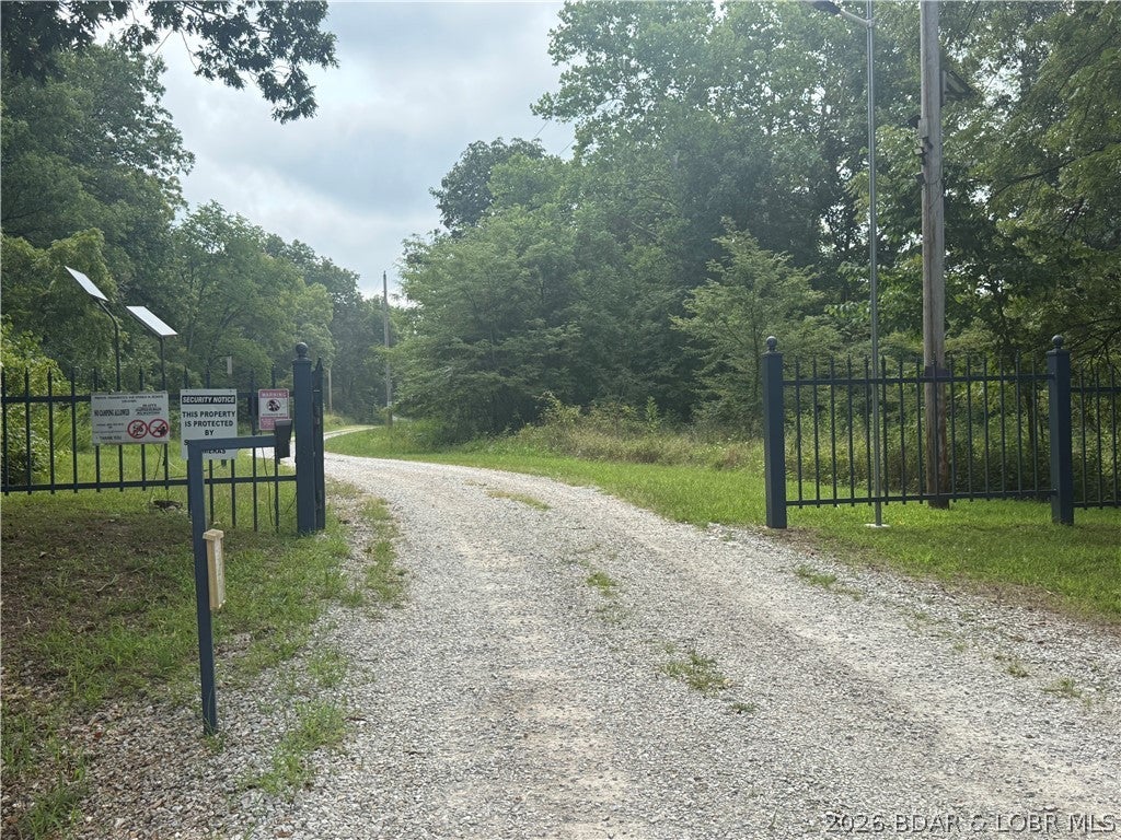 Discover your own private retreat in the gated community of Forbes Lake of the Ozarks. This beautiful 3-acre, mostly wooded parcel on Paulson Rd in Edwards, Missouri, offers the perfect setting to build your dream cabin, weekend getaway, or peaceful full-time residence. Surrounded by nature, you'll enjoy abundant wildlife, privacy, and the tranquility of the Ozarks. As a Forbes landowner, you'll have exclusive access to three private lakes and a private fishing pond reserved for property owners. Spend your days fishing from the bank, a fishing platform, or your boat while enjoying the lakes and pond stocked with a variety of fish. You can walk, hike, and enjoy the natural beauty of this area.