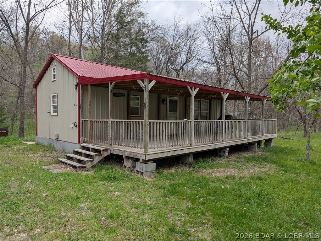 Simple secluded lake living. This property features two conjoined lots that are each 105x105 feet, surrounded by trees and nature. An unfinished prefab home featuring two lofts along with a storage shed has been placed on the property. It is ready for your personal touches. This property is located off of Dodd's Camp Road, the 49 mile marker of the Lake of the Ozarks and features a less than 5 minute walk to private access (by permission) You can customize the space to your personal liking and create your very own simple and secluded oasis.